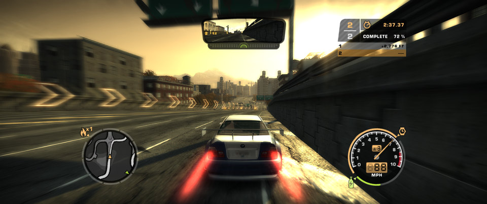 SpeedBreaker gameplay: the chase camera behind a racing car at sunset