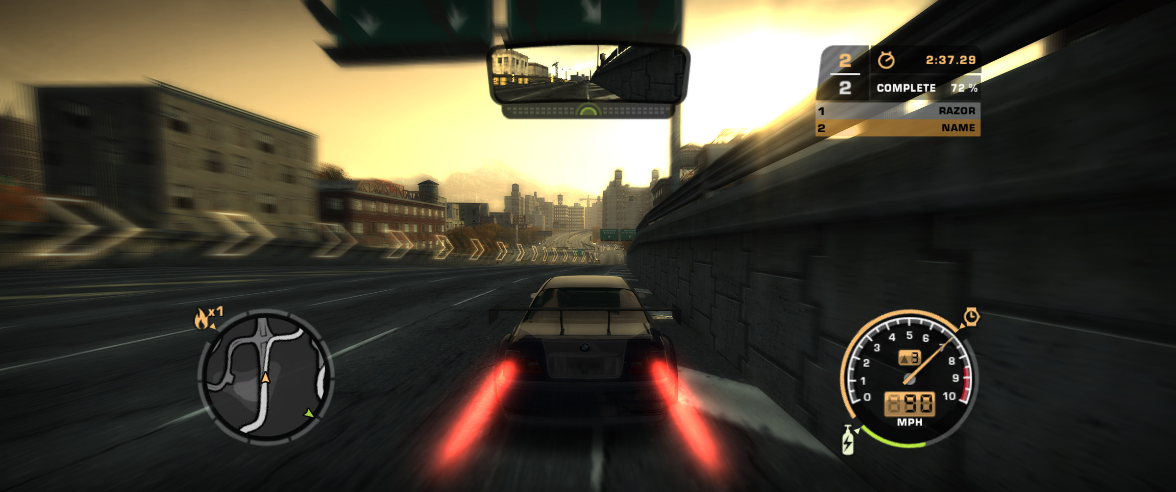 Chase cam, 21:9: the camera behind the player's car, nitrous lit, heading into the setting sun